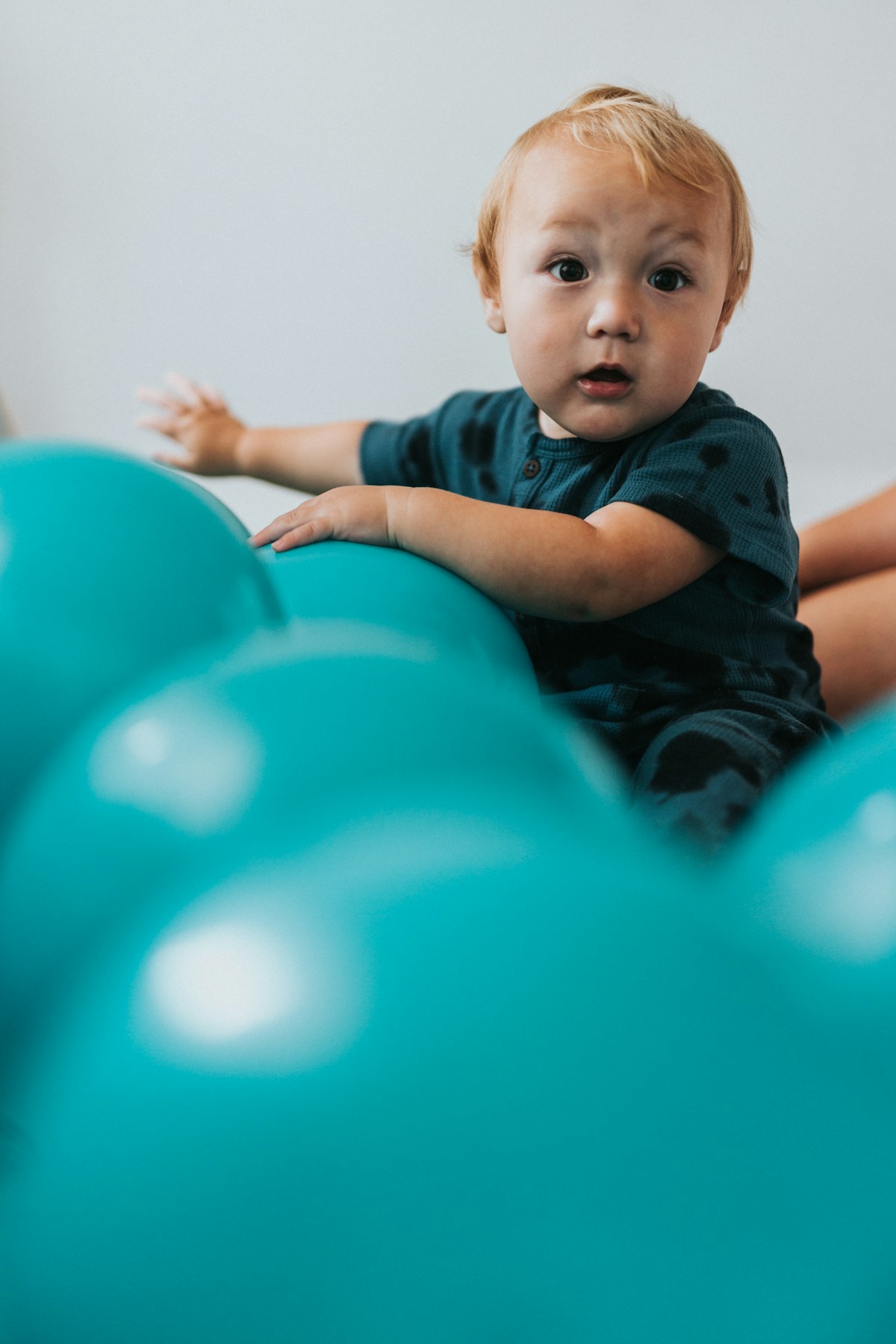 Child celebrating a birthday among balloons